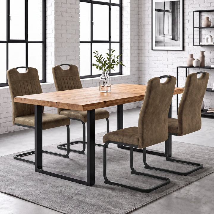 [Dark Brown] Four high-back dining chairs with black loop metal frames around a wood table with a glass plant vase.