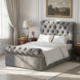 [Dark Grey] Angled bedroom view of Chesterfield bed showing tufted headboard, footboard, curtains, and lamp.