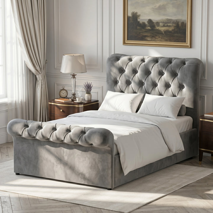 [Dark Grey] Angled bedroom view of Chesterfield bed showing tufted headboard, footboard, curtains, and lamp.