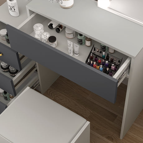 Dark grey dressing table with drawer storage and matching stool for a complete vanity setup.