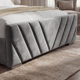 Bottom-side view of the dark grey ottoman bed, emphasizing the sturdy frame and modern aesthetic placed on a rug