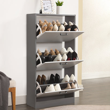 Fully opened wooden shoe cabinet showing three sections filled with up to 18 pairs of footwear including wellies and boots.