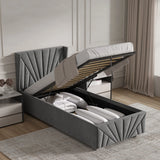 Grey upholstered bed with storage compartments in a bedroom setting.