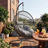 [Dark Grey] Hanging egg chair on a wooden deck with a table and outdoor setting