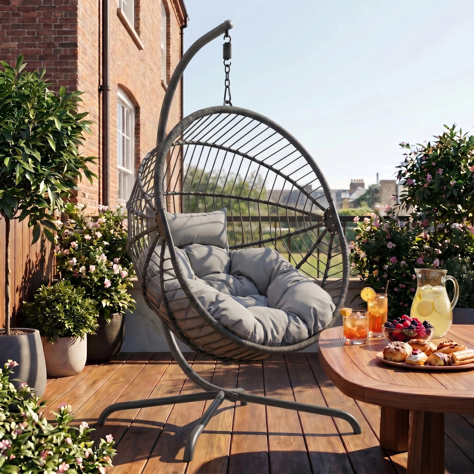 [Dark Grey] Hanging egg chair on a wooden deck with a table and outdoor setting