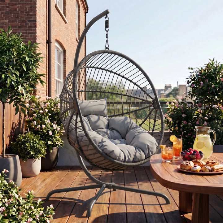 [Dark Grey] Hanging egg chair on a wooden deck with a table and outdoor setting