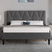 Grey upholstered bed with tufted headboard in a bedroom setting