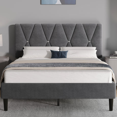 Grey upholstered bed with tufted headboard in a bedroom setting.