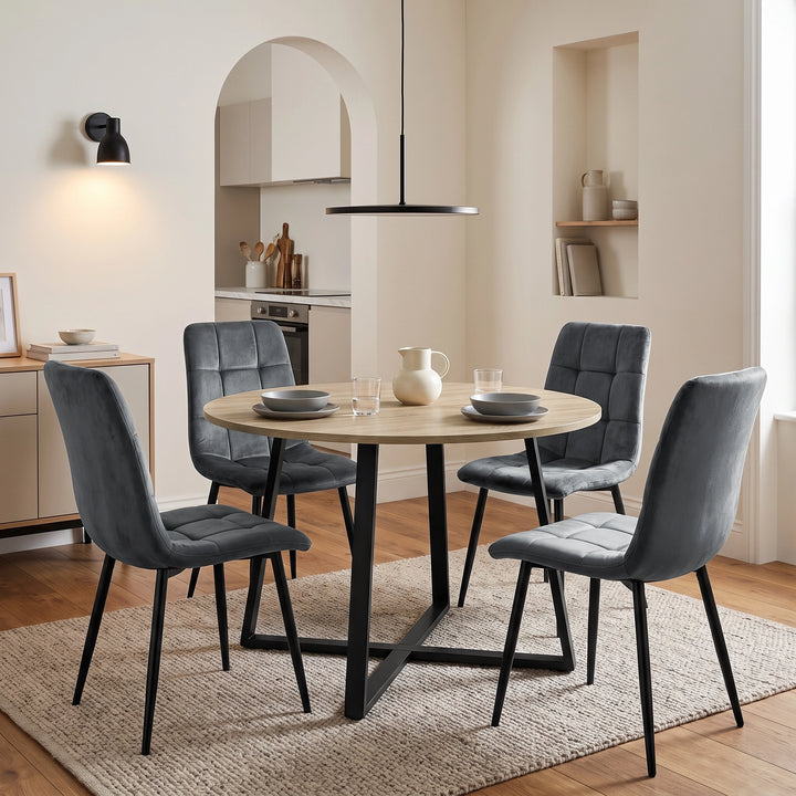 [Dark Grey | Set of 4] Velvet dining chairs around a round table, showing tufted cushions, curved backs and black metal legs.