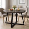[Dark Wood] Round dining table in a bright room with flowers, fruit and candles on top, set between beige chairs.