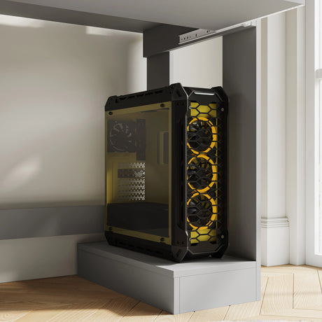 Black and yellow gaming PC tower with triple front fans placed under a compact home office computer desk with shelves for working, reading & gaming.