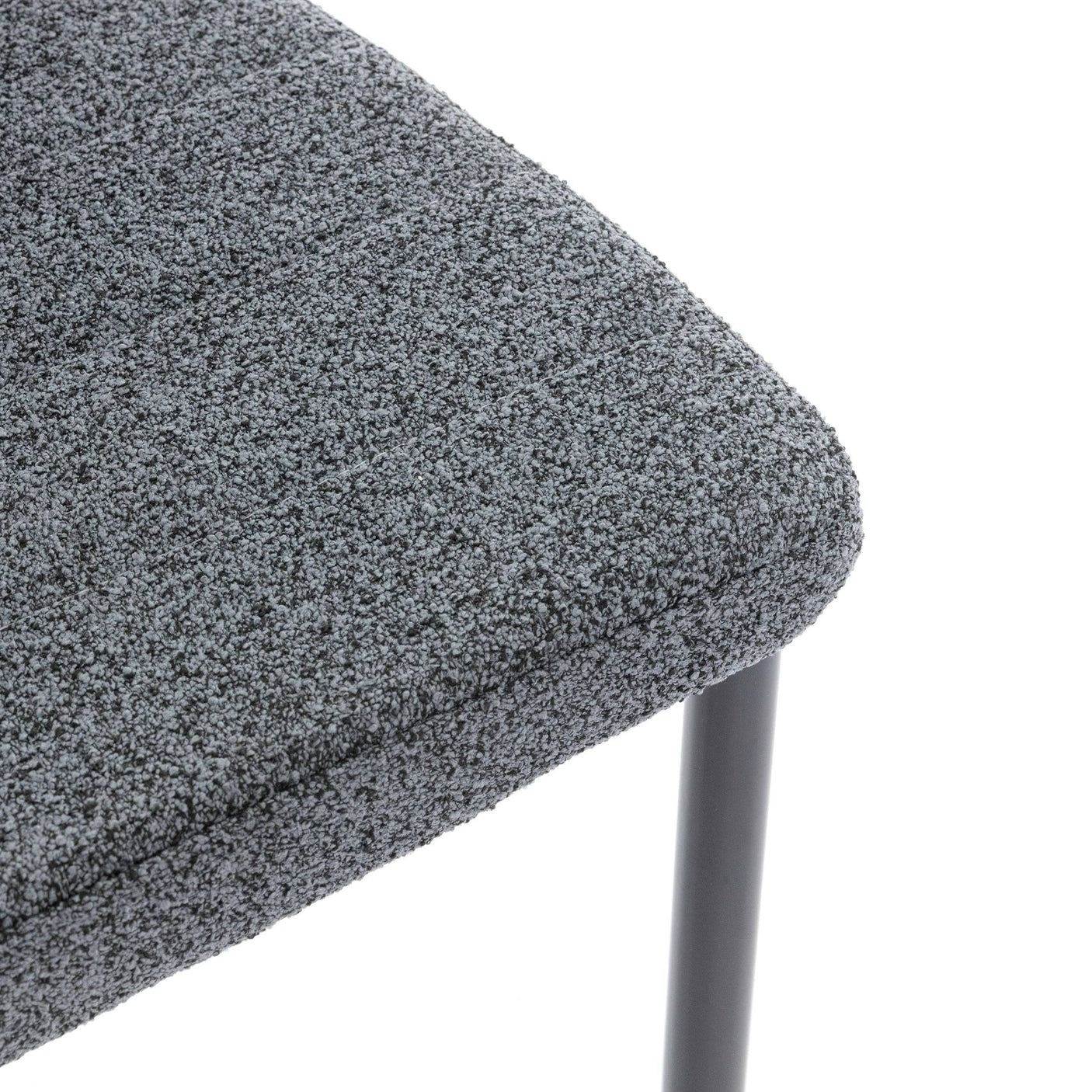 Close-up of dining chair sale set of 4 with grey textured upholstery and black metal legs