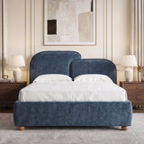[Double | Blue] upholstered bed with a dual rounded headboard and matching footboard, dressed in white and beige bedding, set against a wood-paneled wall
