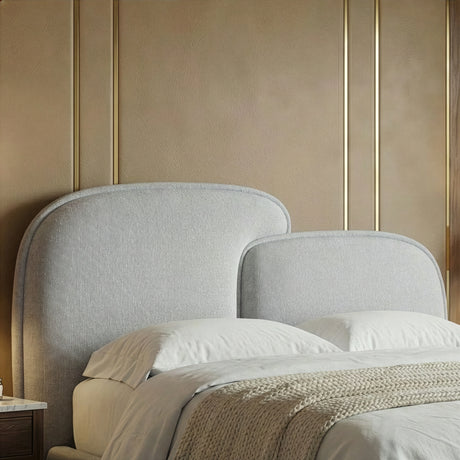 Close detail of the curved splitted grey headboard showing fabric texture and rounded top edge