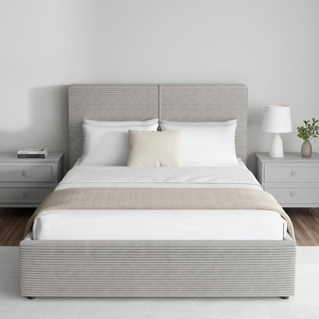 Corduroy ribbed velvet upholstered ottoman bed frame with storage in light grey, featuring a lift-up base and padded headboard, shown in a modern bedroom.