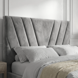 Close-up of the grey ottoman bed headboard, showing the velvet upholstery and structured design.