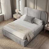 Grey fabric double bed frame positioned at a slight angle in a modern bedroom setting