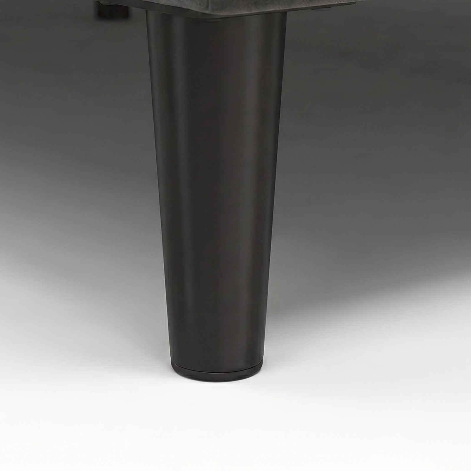 [Double | Grey] Velvet Bed Frame close-up of single black tapered solid wood leg on plain background