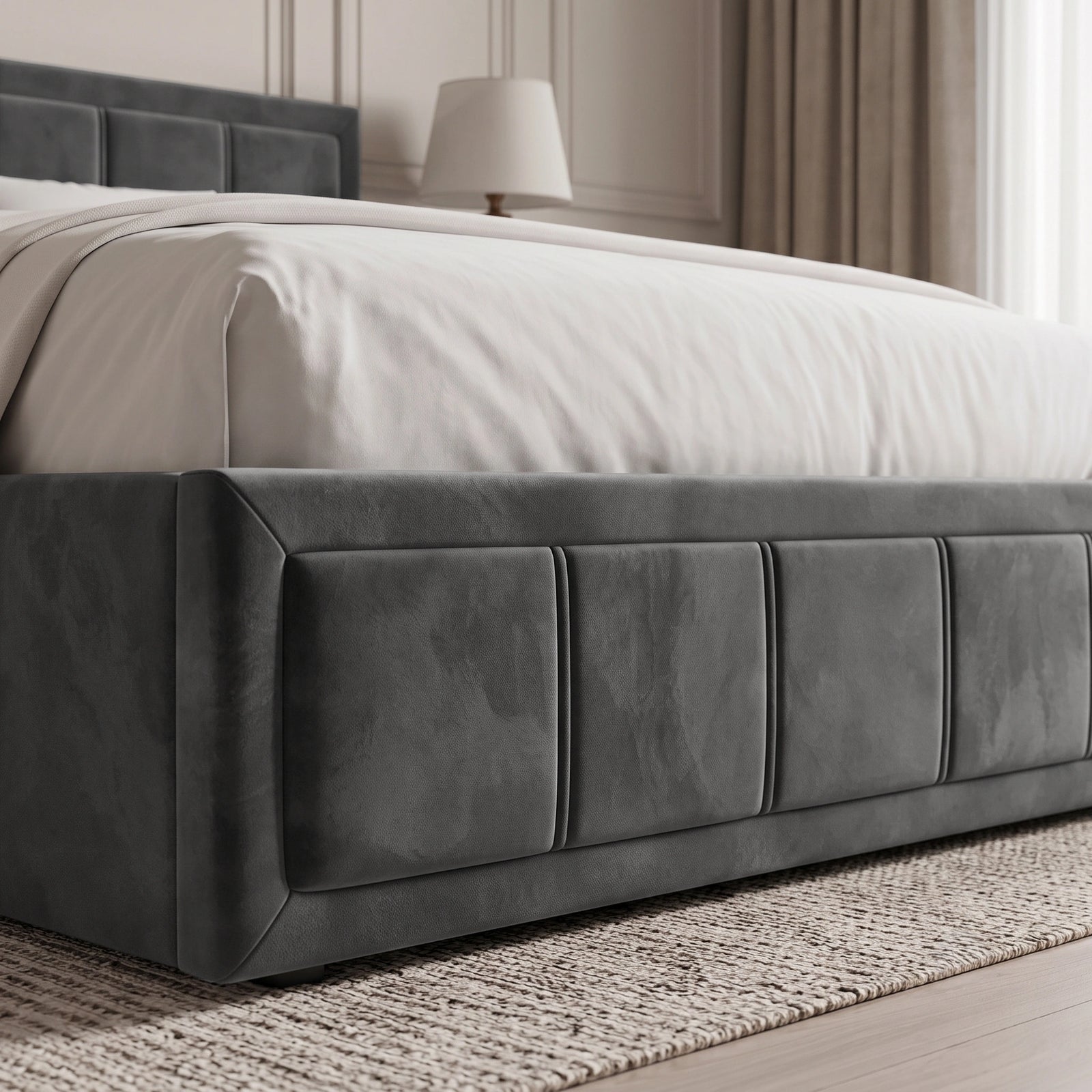 [Double | Grey] upholstered bed frame with a padded headboard and tufted side panels, shown with white bedding in a softly lit bedroom setting.