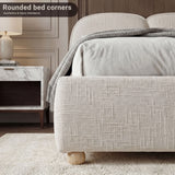 Beige double low bed frame with a soft upholstery and a simple footboard, offering a cozy and modern aesthetic