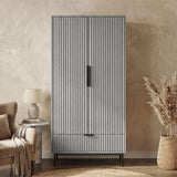 Flutrina design 2 door wardrobe with black door handles and legs placed against a wall in a room