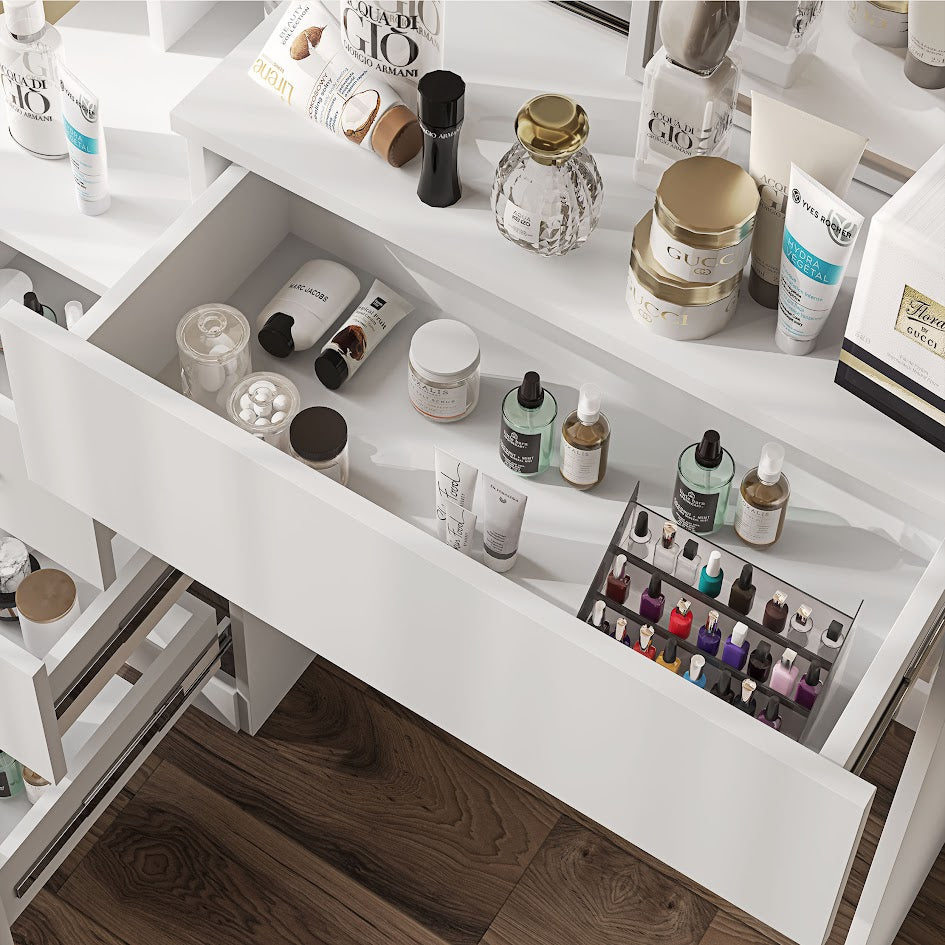 White dressing table decor with open drawer displaying cosmetics and nail polish