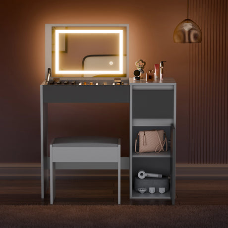 Dressing table with illuminated mirror and various items on a warm-toned wall.