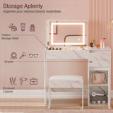 Makeup vanity with storage compartments and illuminated mirror on a pink background