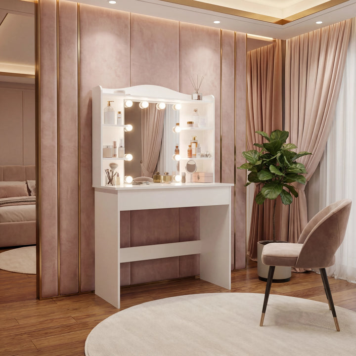 [White] dressing table with mirror and bulbs, white finish, pink velvet wall behind, leafy houseplant beside