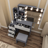 Dressing tables with mirrors and lights, grey drawers, shelves, and stool for organized storage.