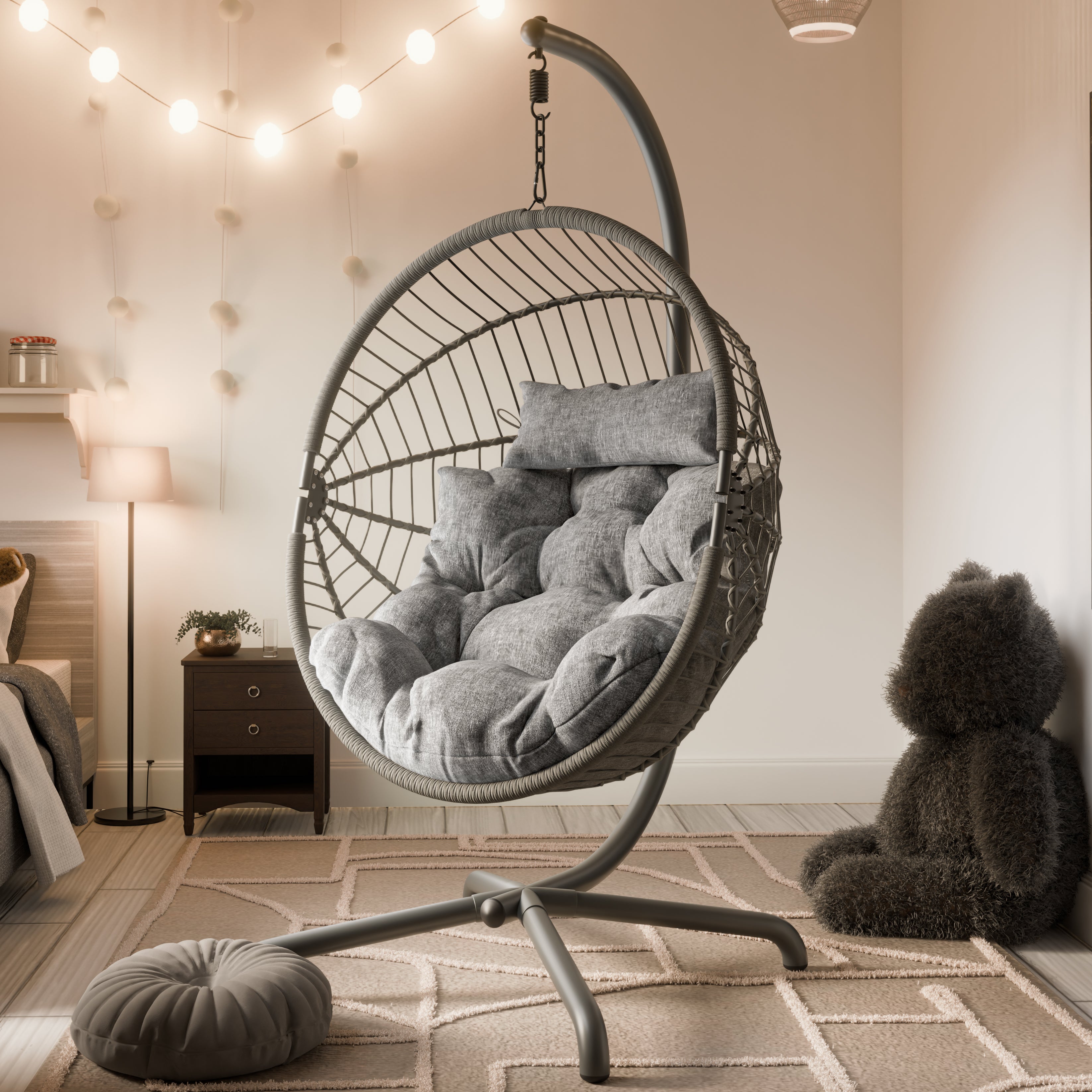 Indoor egg chair hanging from ceiling with a grey cushion, ideal for cozy living spaces.