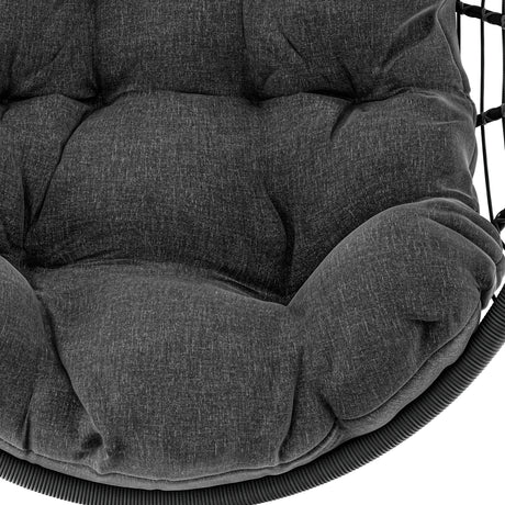 Egg chair hanging with plush black cushions and durable woven frame for comfort.