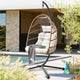 Egg chairs for garden seating, featuring a rattan frame and striped cushions for outdoor comfort.