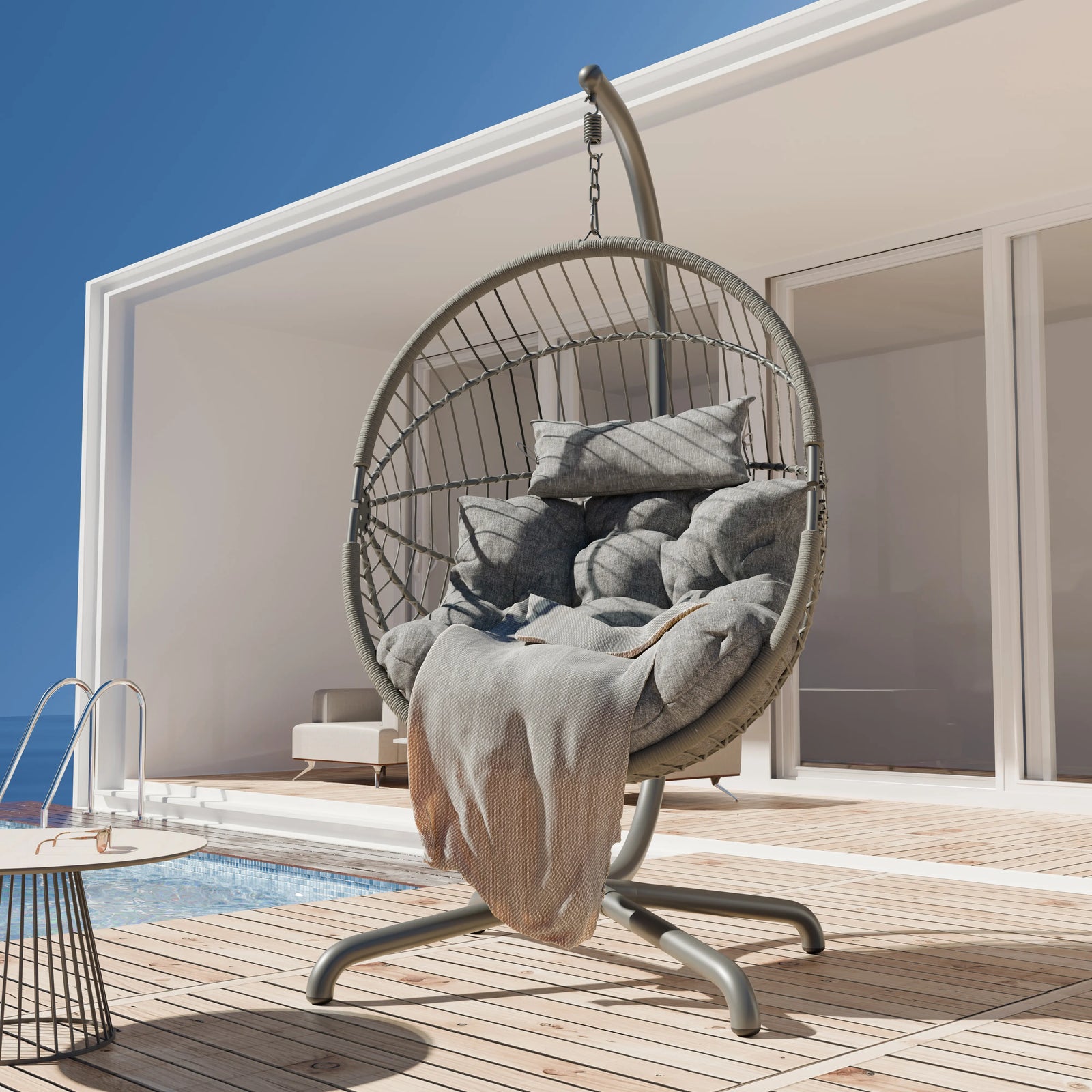 [Light Grey] Hanging egg chair lifestyle shot on wood deck, light grey upholstery and curved frame