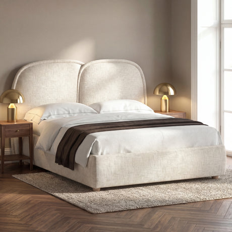 [Double | Beige] Upholstered bed from the side with organic rounded headboard puffs and brown throw draped