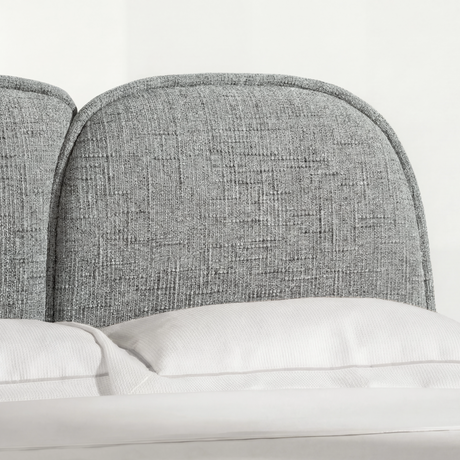 [Double | Grey] Headboard edge detail with cloud-shaped organic curve and piped seam in natural light