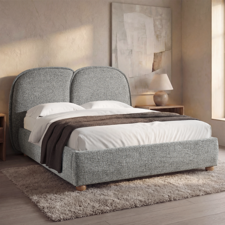 [Double | Grey] Upholstered bed from the side with organic rounded headboard puffs and brown throw draped