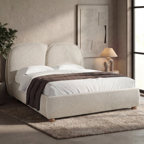 [King | Beige] Upholstered bed from the side with organic rounded headboard puffs and brown throw draped