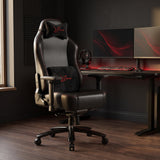 [Black] Xstriker High-Back Ergonomic Gaming Chair with Lumbar Support styled at a modern sit-stand desk setup.