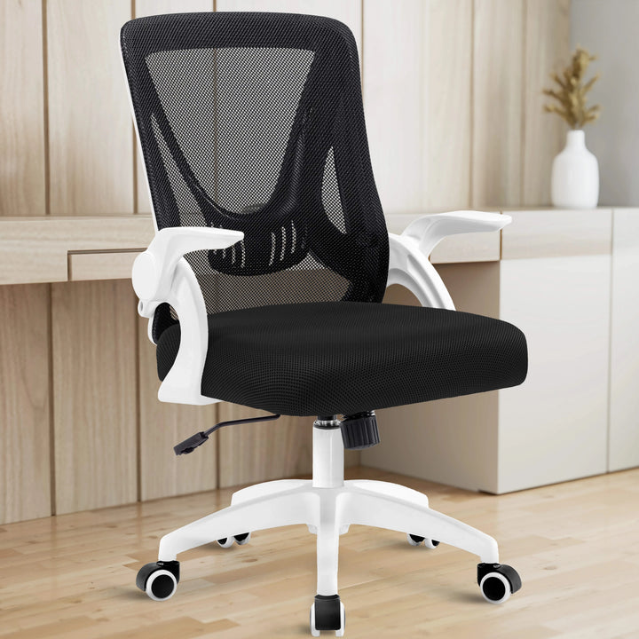 [White] The white mesh chair in a home office, placed near a desk, creates a clean and ergonomic workspace.