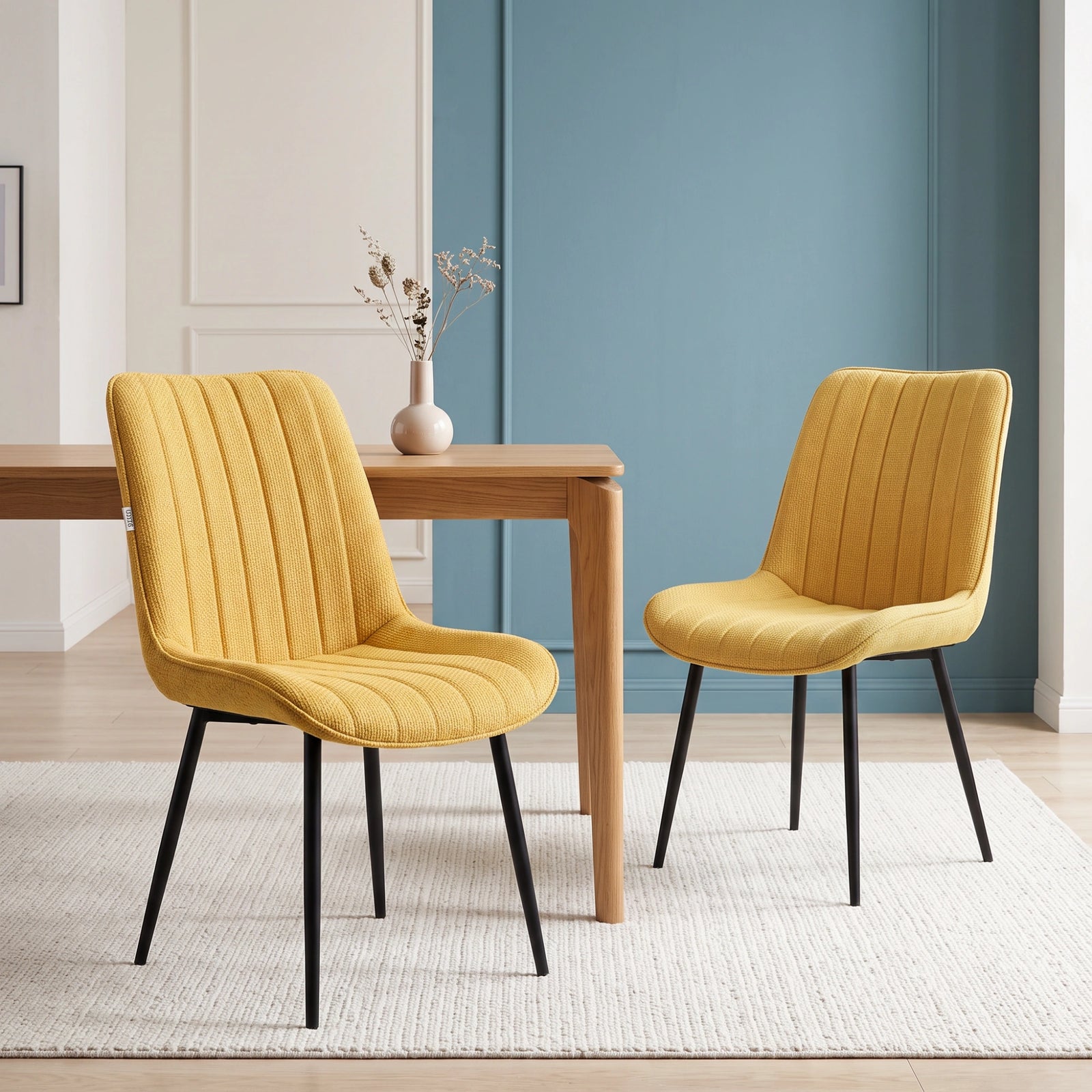 [Mustard | Set of 2] Two fabric dining chairs beside a table, showing curved backs and slim black metal legs