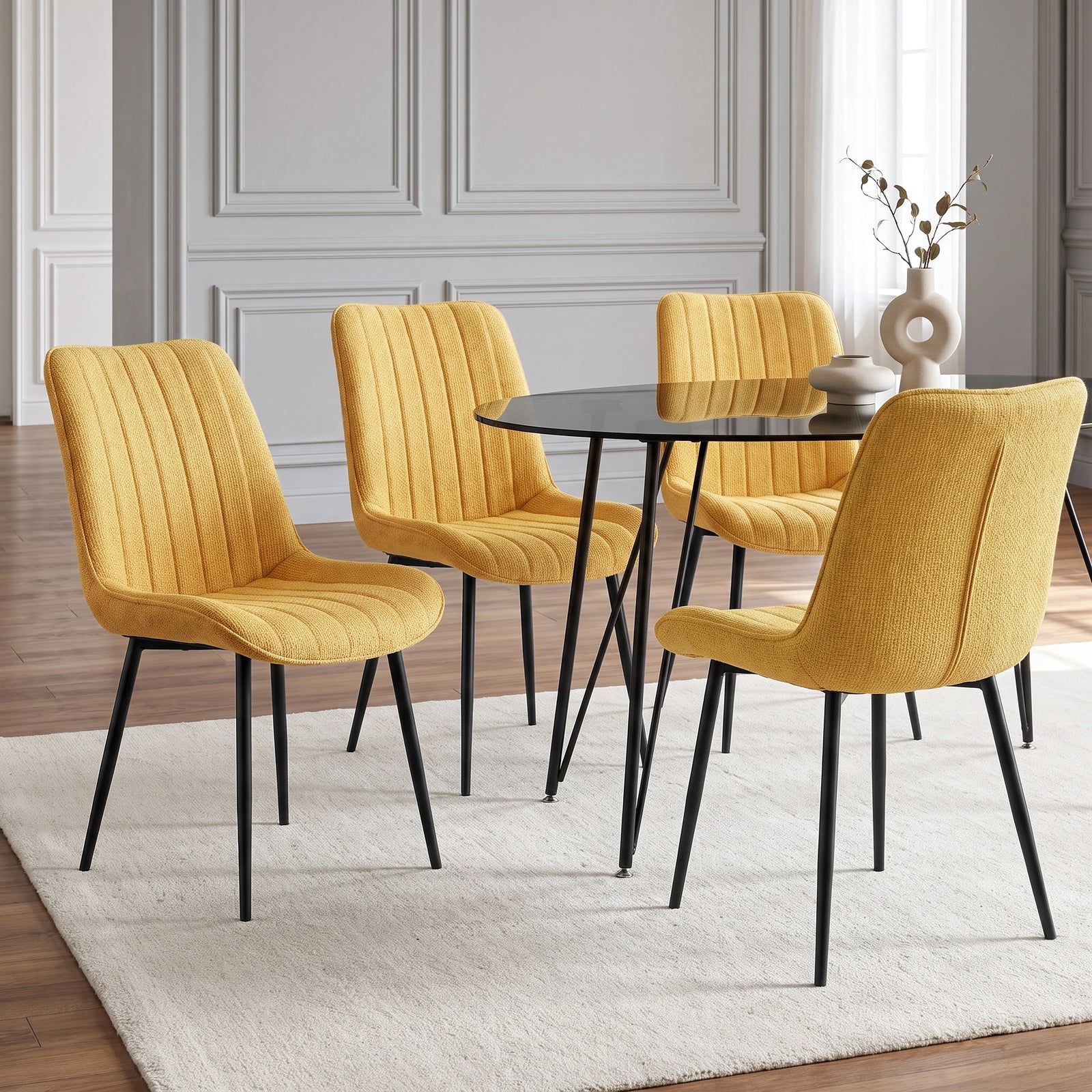 [Mustard | Set of 4] Four fabric dining chairs around a black round table in a neutral dining room