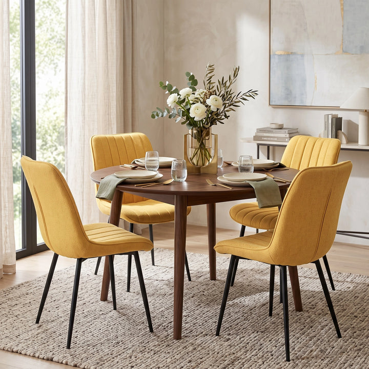 [Mustard | Set of 4] Four fabric dining chairs around a round table in a bright dining room