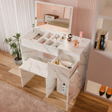 [White Marble] Vanity from above, top tray sectioned for brushes, stool slid out left, bed visible behind