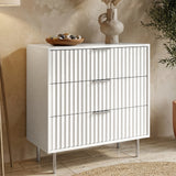 [White] painted three drawer chest from the right with vertical fluted fronts and silver cylindrical legs