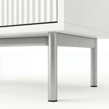 [White] flutrina chest of drawers underside view of the silver metal legs and connecting front frame