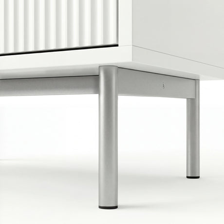 [White] flutrina chest of drawers underside view of the silver metal legs and connecting front frame