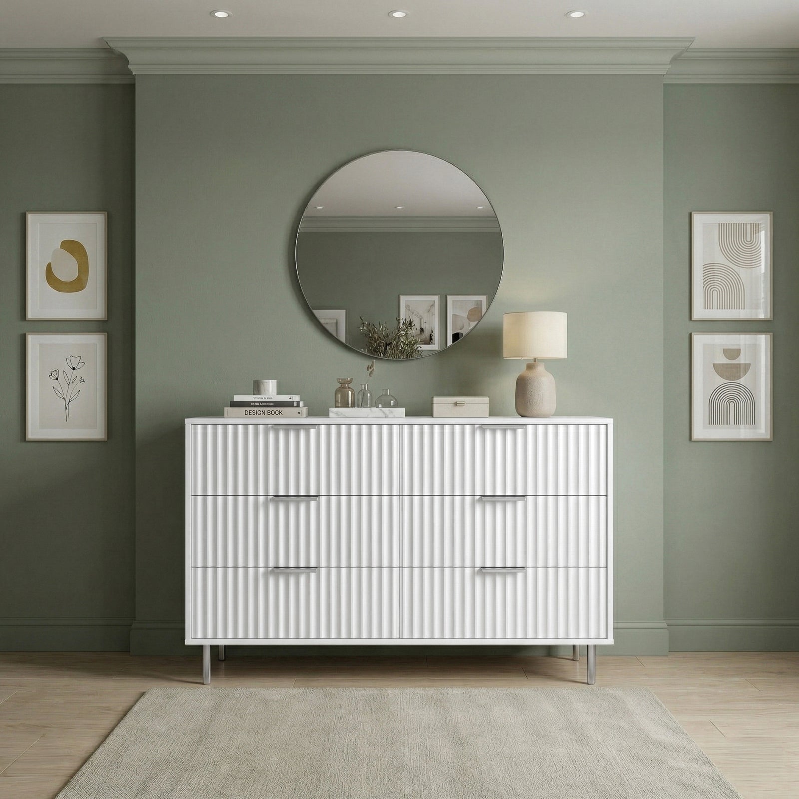 [White] chest of drawers with decorative items against a green wall placed in a natural light room front view