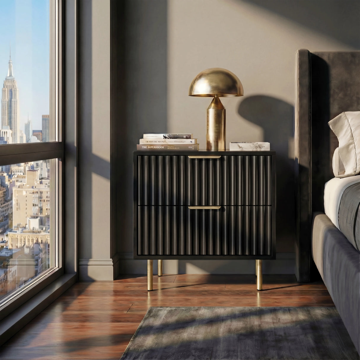 Black nightstand unit with two drawers in flutrina design placed against a wall in a bedroom setting
