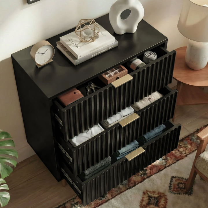 [Black] painted chest with drawers open, showing organised internal storage compartments